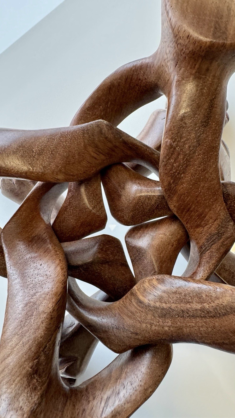 Hand-carved natural wood interlocking folding stand .