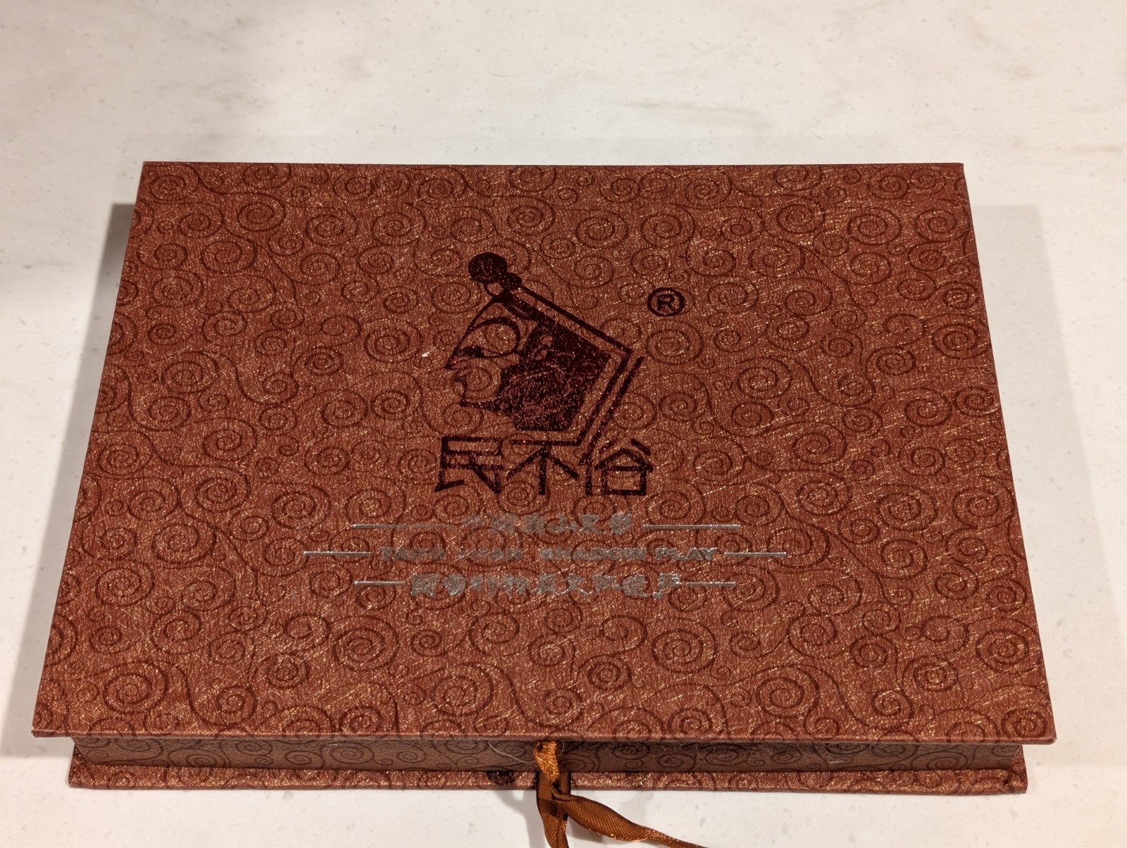 Vintage Chinese silk brocade gift box containing a Tang Shan shadow play item.