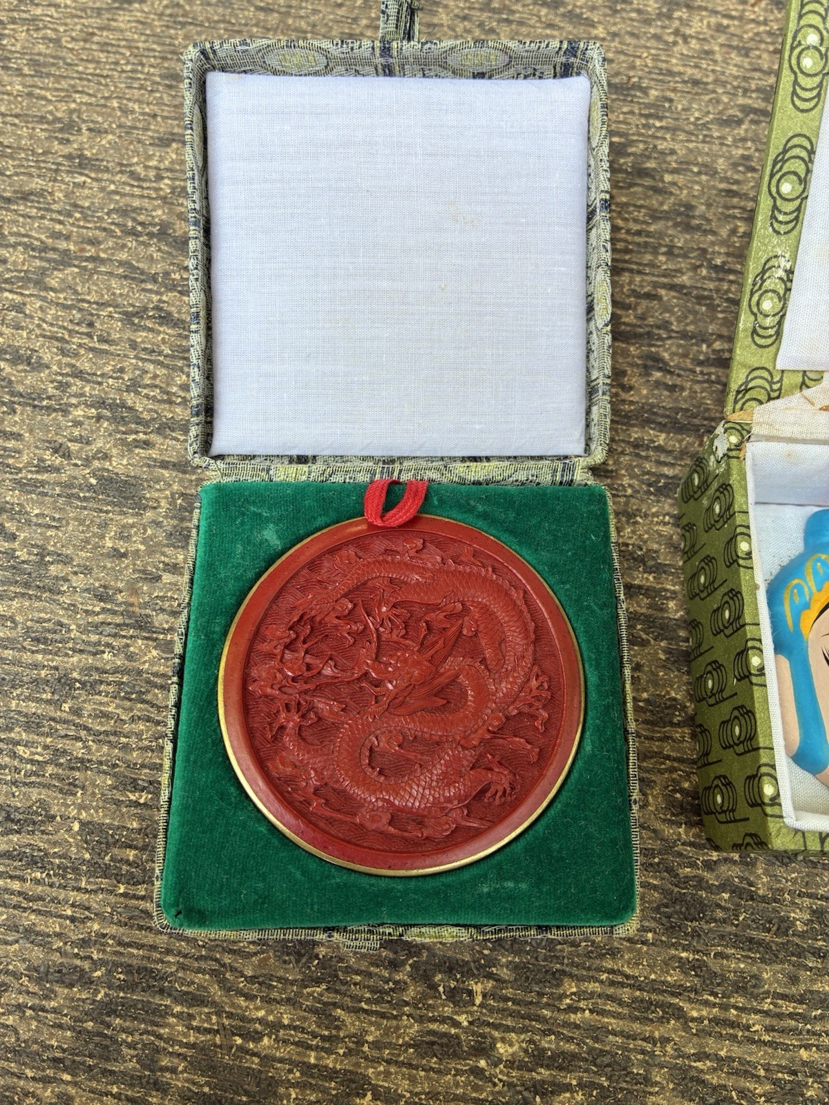 Chinese carved lacquer medallion and ceramic face mask miniatures