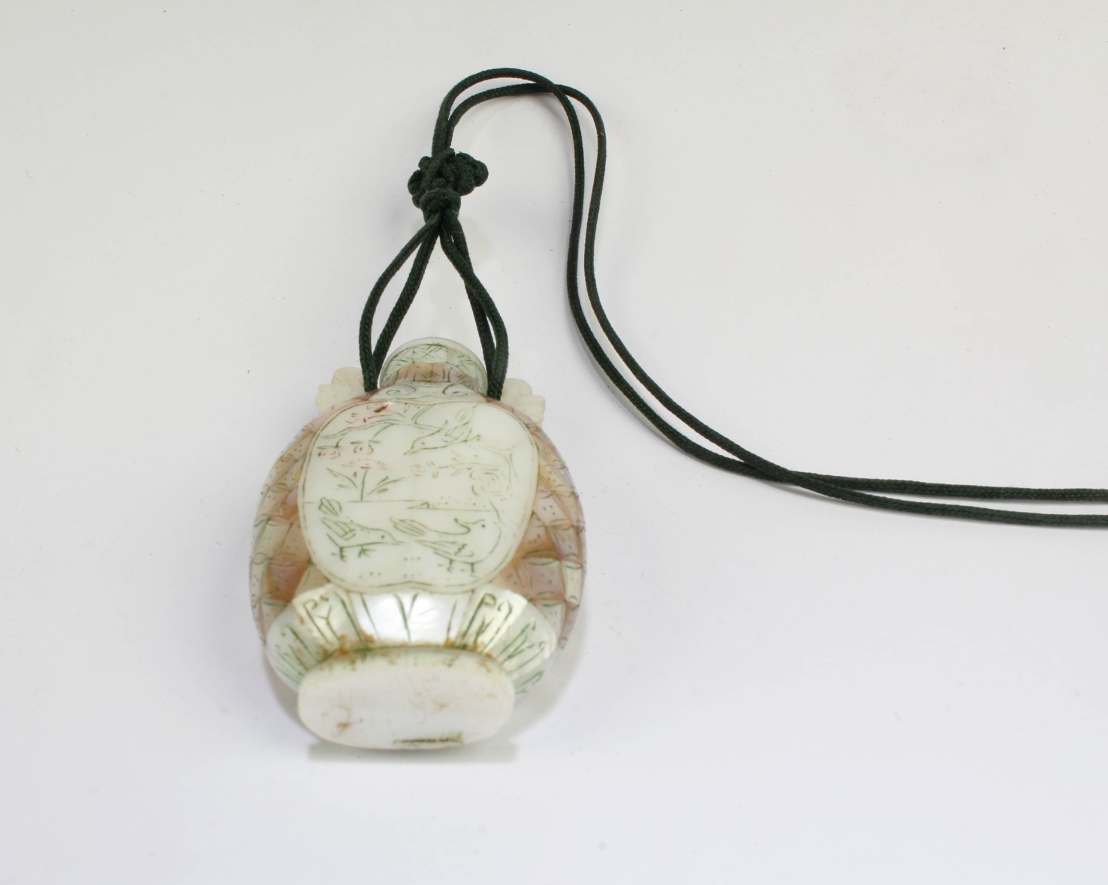 A Mother-of-Pearl Snuff Bottle, attached to a strine