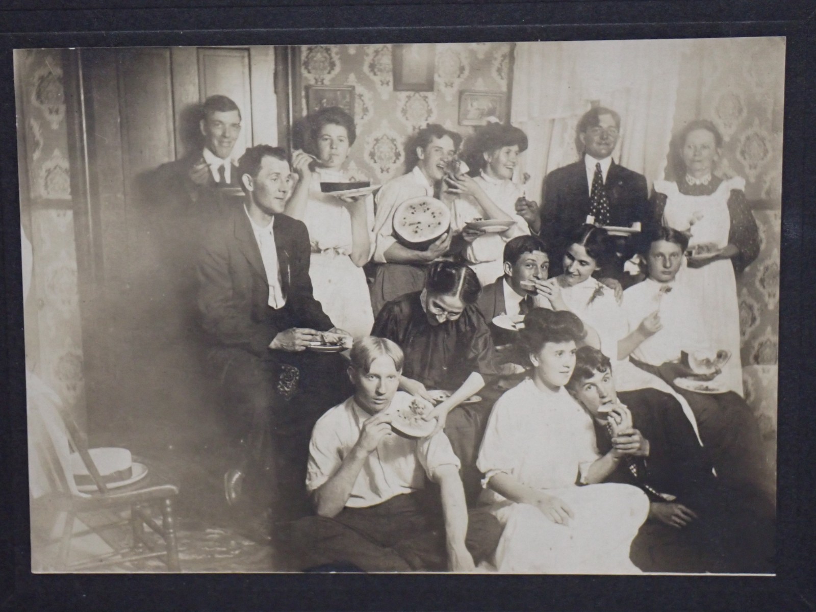 Antique 1910s Photo Group Eating Watermelon Indoors Parlor Edwardian Mounted B&W