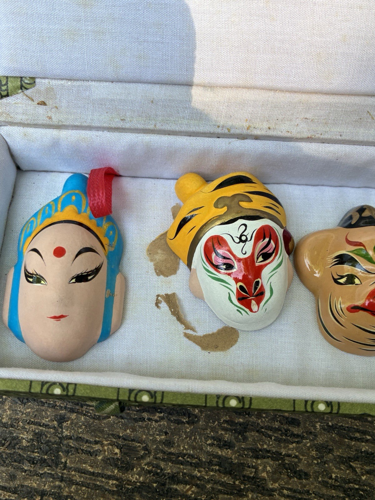 Chinese carved lacquer medallion and ceramic face mask miniatures